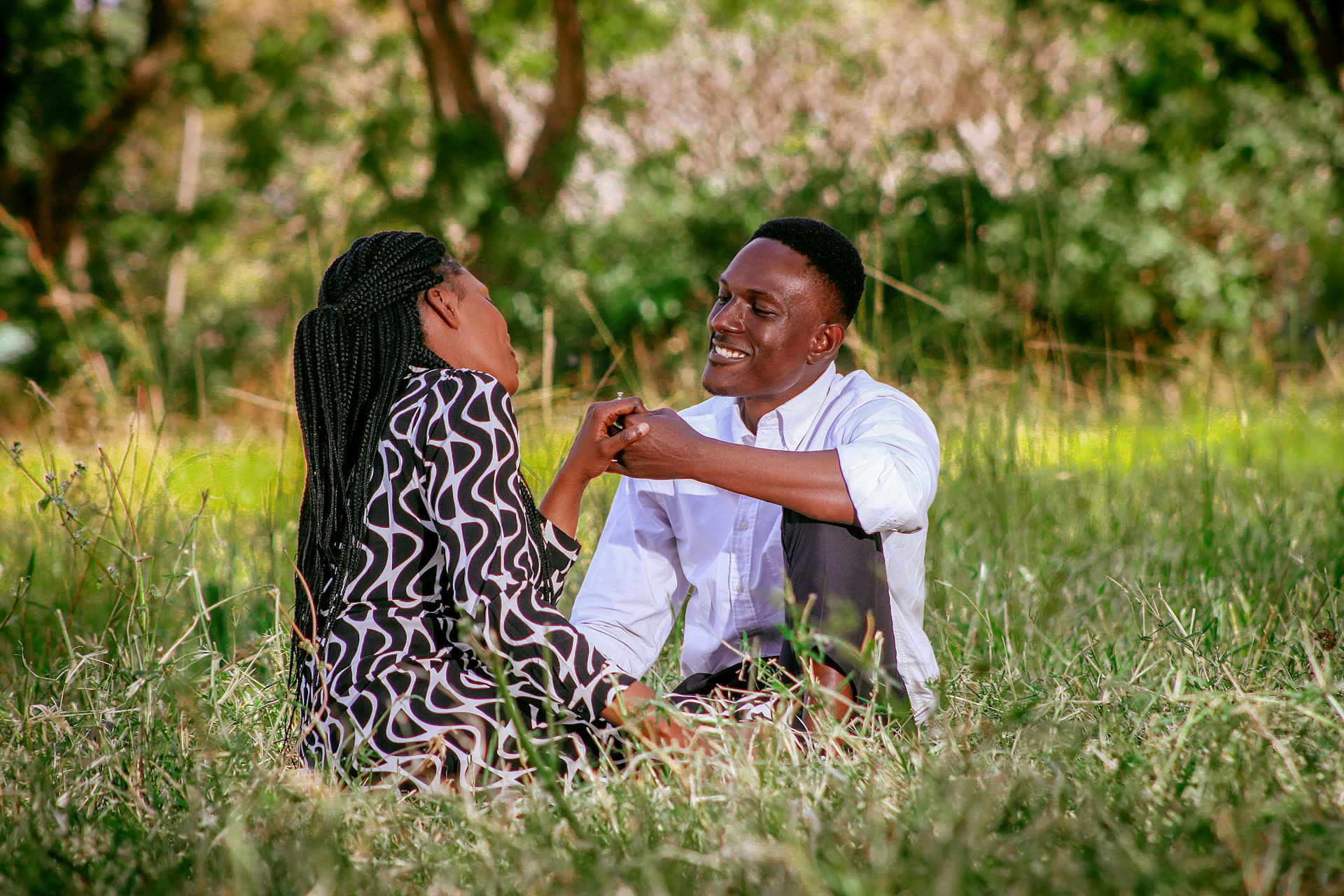 A man and a woman sitting in the grass